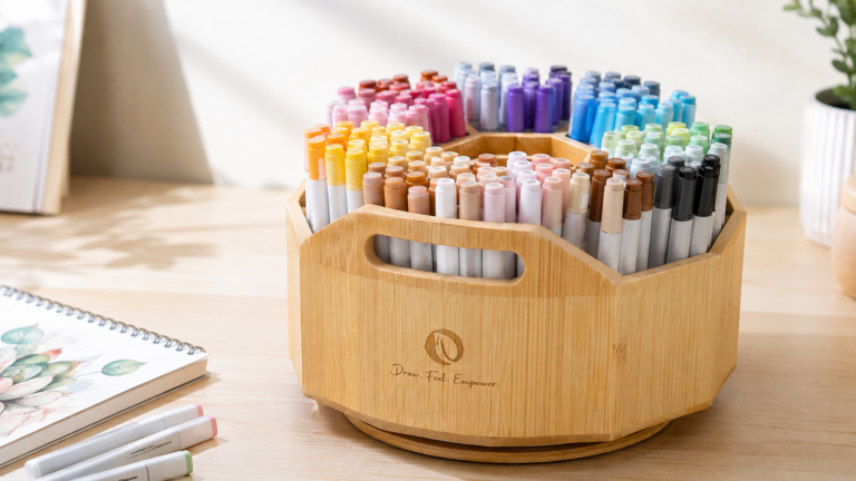 Ohuhu Rotating Marker Organizer filled with colourful alcohol markers on a desk